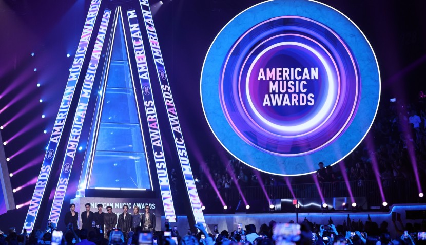 BTS speak onstage during the 52nd American Music Awards